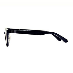 May include: Black eyeglasses with a rectangular frame and a thin, dark temple. The glasses have a silver nose bridge and a small, gray stripe detail on the temple. The lenses are clear.