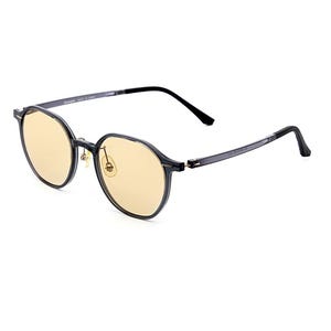 May include: Round-framed glasses featuring translucent dark gray frames and light yellow-tinted lenses. The eyewear includes thin, dark gray temples with black tips and gold-toned nose pads, providing a clear view of the front and side profile.