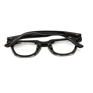 May include: A pair of black eyeglasses with a thick frame and folded temples. The frames feature a glossy finish with a subtle translucent light-colored accent along the bottom edge of the lenses, showcasing a classic rectangular shape.