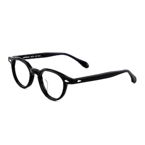 May include: Black eyeglasses with round lenses and a thick frame. The glasses have a keyhole bridge and a small diamond-shaped detail at the temples. The text "LENNON 46" is printed on the frame.