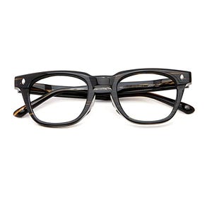 May include: Black and brown tortoise shell eyeglasses with a thick frame. The temples feature a small silver-toned metal accent on the outer corners. The inner temple arm displays the text Reinventing Vintage and other small printed details.