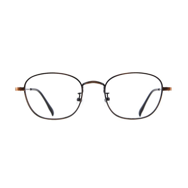 May include: Round-framed spectacles with a black metal frame and brown accents on the temples. The lenses are clear, and the bridge and nose pads are a dark brown colour. The spectacles have a classic, minimalist design.