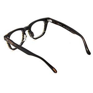 May include: Tortoiseshell-patterned eyeglasses with a dark brown and black frame. The inner temple arm features the text MILLER 46 46-22 145 COL.3. These glasses have clear lenses, a thick bridge, and curved temple tips for a secure fit.