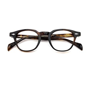 May include: Tortoiseshell-patterned eyeglasses with a rounded frame shape. The frames feature silver-toned diamond-shaped accents on the outer corners and temples. The inner temple arm displays the text Reinventing and other small markings.