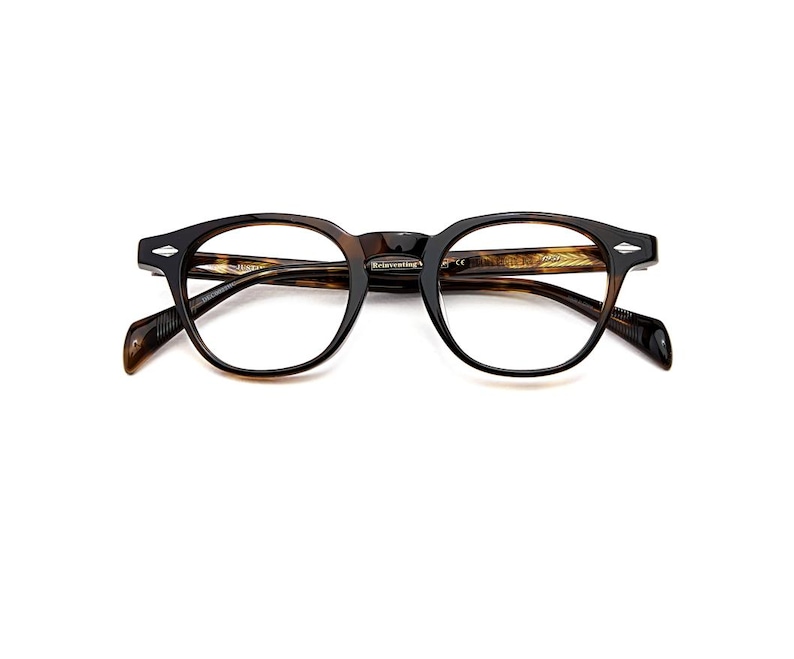 May include: Tortoiseshell-patterned eyeglasses with a rounded frame shape. The frames feature silver-toned diamond-shaped accents on the outer corners and temples. The inner temple arm displays the text Reinventing and other small markings.