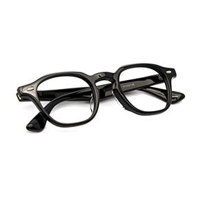 May include: Glossy black eyeglasses featuring a thick, rounded rectangular frame with silver-toned metal rivets at the hinges. The inner temple arm displays the printed text 47 23-148, indicating the frame measurements in millimeters.