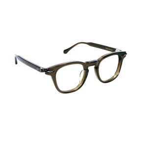 May include: A pair of eyeglasses with a dark olive green frame. The glasses have a rectangular shape with rounded edges and clear lenses. The temples are thin and extend back to curved ear pieces.