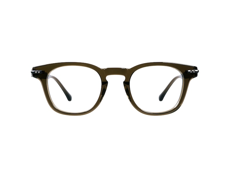 May include: Olive green eyeglasses with a rounded square frame. The glasses have clear lenses and dark temples. The frame is a solid color with a matte finish. The glasses are set against a white background.