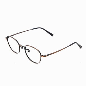 May include: Oval spectacles with a bronze-coloured frame and black temples. The lenses are clear, and the glasses have a classic, minimalist design. The frame is made of metal.