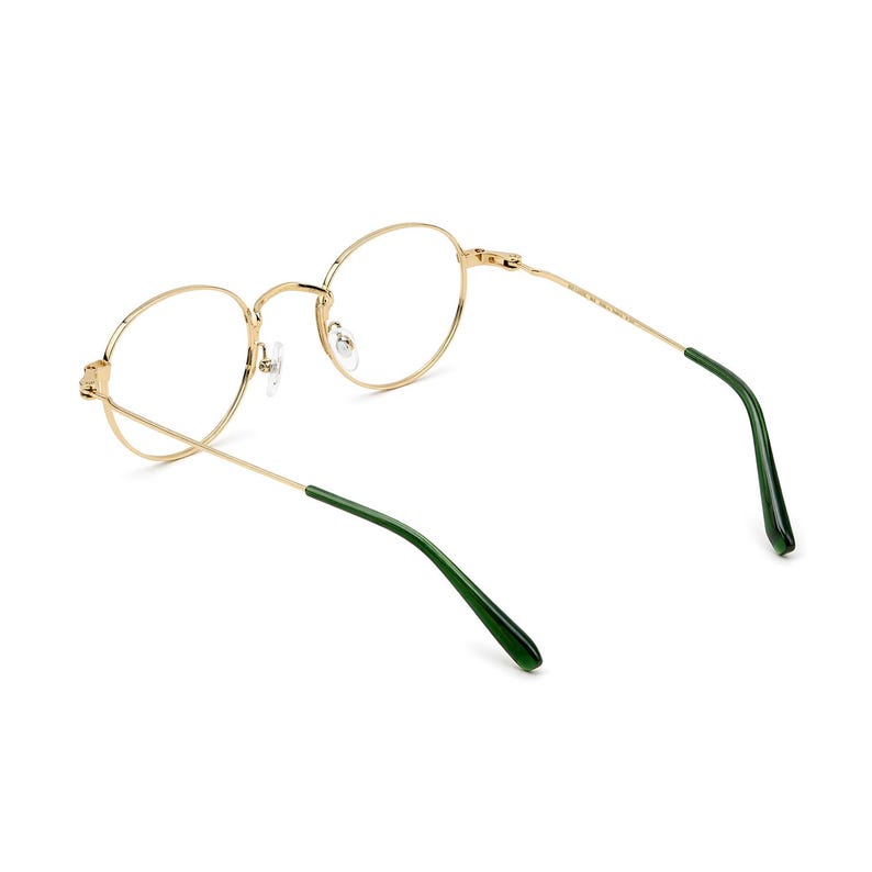 May include: Gold-rimmed eyeglasses with a classic round frame design. The temples are a contrasting dark green color. The glasses are shown against a white background.