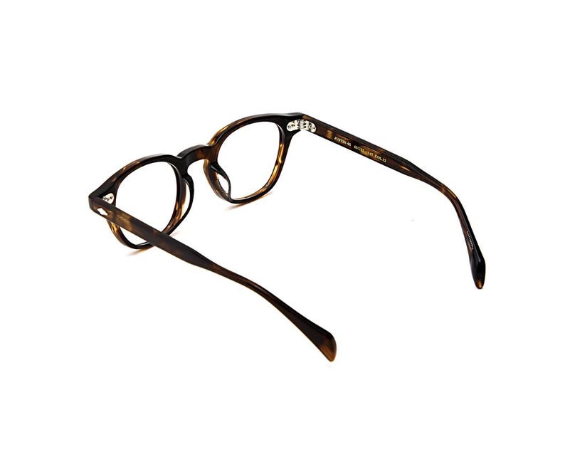 May include: Tortoiseshell-patterned eyeglasses with a rounded frame shape. The inner temple arm features gold-toned text that reads "POKER 46" followed by "MADE IN ITALY". The glasses have clear lenses and a glossy finish on the acetate material.
