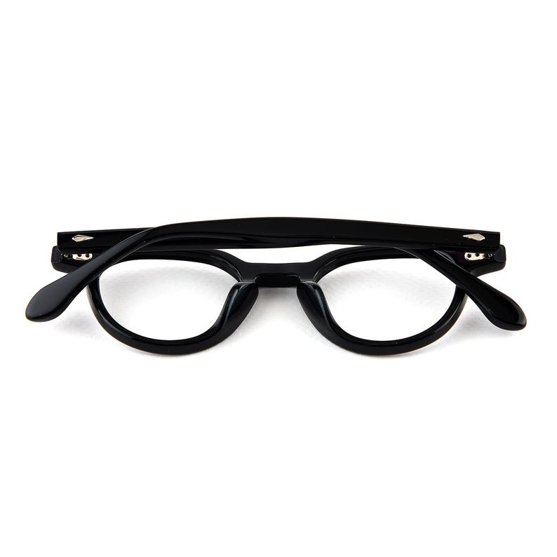 May include: Black, round-framed eyeglasses with a keyhole bridge. The glasses have a classic design with thick, glossy black frames and clear lenses. The arms are also black and extend to the temples.