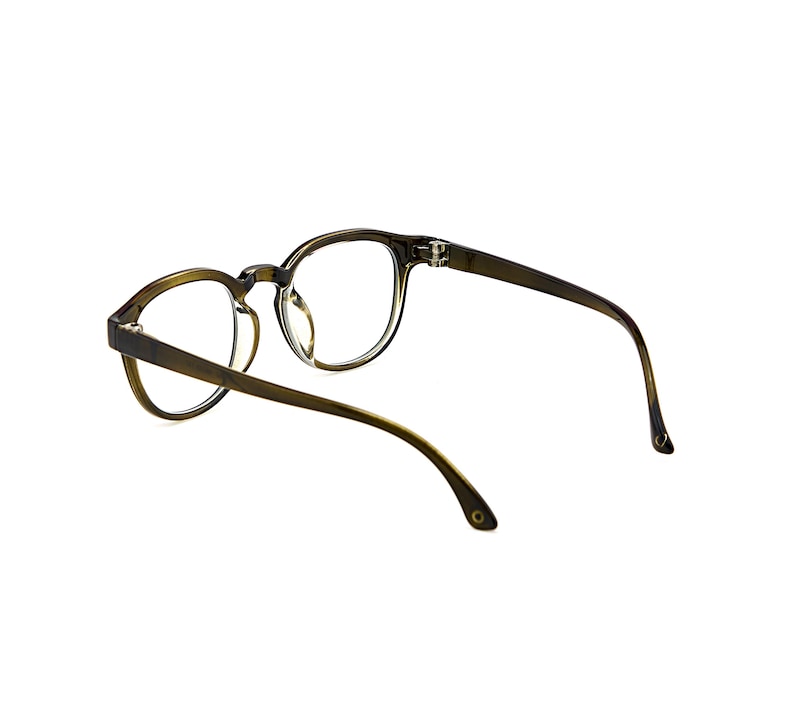 May include: A pair of olive green eyeglasses with round frames and clear lenses. The glasses feature a thin bridge, curved temples, and visible hinges connecting the frame front to the arms, showcasing a translucent finish throughout the structure.