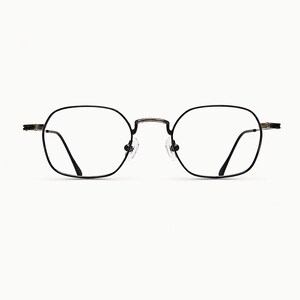 May include: Eyeglasses with a thin, dark metallic frame featuring a rounded square shape. The glasses have clear lenses, a bridge connecting the two rims, and adjustable nose pads. The temples extend outward from the sides of the frame.