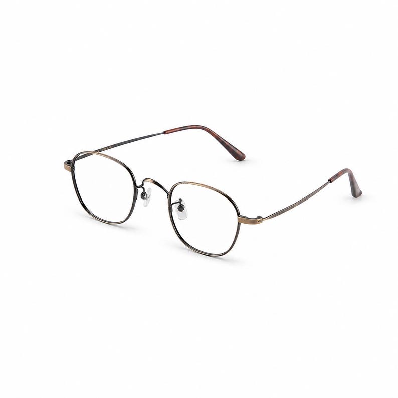May include: A pair of eyeglasses with a thin, dark metal frame and oval lenses. The frame has a bronze-colored finish around the lenses and temples, with brown temple tips. The glasses are set against a white background.