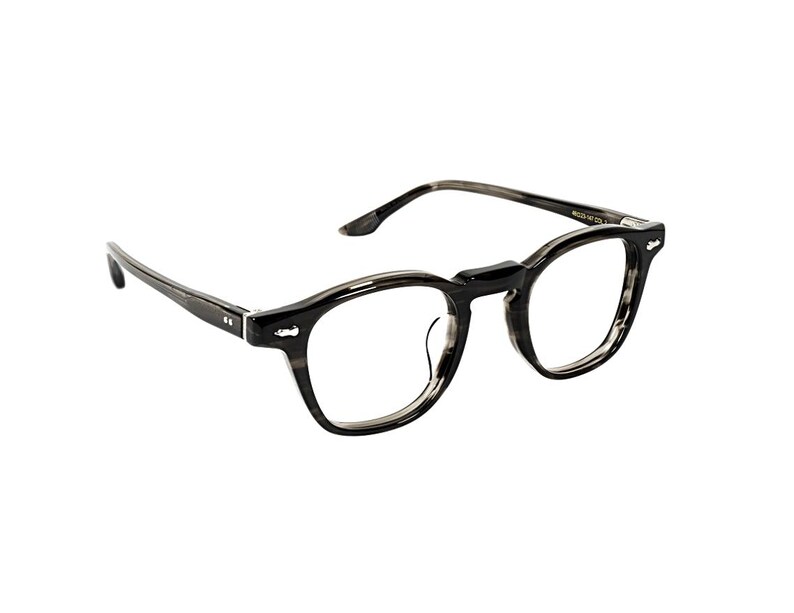 May include: A pair of eyeglasses with a dark gray and black marbled pattern. The frames have a rounded, rectangular shape. The temples are thin and extend back to the ear. The lenses are clear.