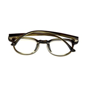 May include: Tortoiseshell-patterned eyeglasses with a rounded frame shape and clear lenses. The frame features a dark brown and amber mottled design with a glossy finish, thin temples, and a bridge connecting the two circular lens rims.