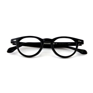 May include: Black, round-framed eyeglasses with a keyhole bridge. The glasses have a classic design with thick rims and temples. The text "Reinventing" is visible on the frame. The eyeglasses are set against a white background.