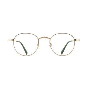 May include: Gold-rimmed eyeglasses with a classic round shape. The frames have a delicate, thin design, and the temples are a dark green color. The glasses are set against a plain white background.