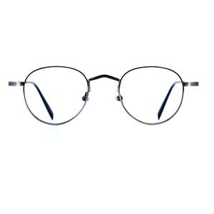 May include: Round eyeglasses featuring a thin, dark metallic frame with a bridge connecting the two circular lenses. The temples extend horizontally from the sides of the frame, showcasing a simple, functional design with clear lenses.