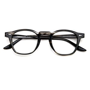 May include: A pair of eyeglasses with a dark, speckled frame. The glasses have a classic, round shape with a keyhole bridge. The text "COMMONWEALTH - R1007" is printed on the frame. The lenses are clear.