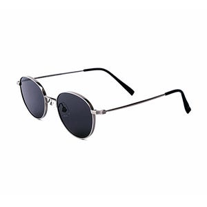 May include: Oval sunglasses with dark lenses and a silver metal frame. The thin temples are black, curving at the ends. The sunglasses are set against a white background.