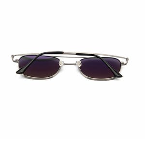 May include: Silver-toned metal frame sunglasses featuring rectangular lenses with a dark purple gradient tint. The thin wire frame includes a double bridge design and black plastic temple tips, showcasing a sleek and functional eyewear construction.