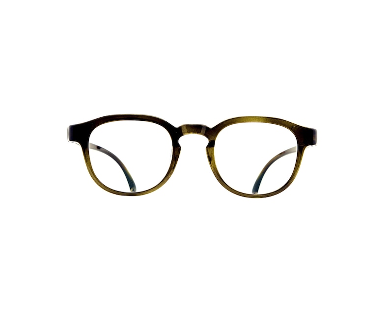 May include: A pair of eyeglasses with a rounded, olive-green frame featuring a subtle gradient effect. The glasses have clear lenses and a bridge connecting the two circular rims, with thin, dark-colored temple arms visible on the sides.
