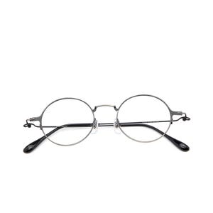 May include: Round eyeglasses featuring a thin, dark metallic frame with a bridge and adjustable nose pads. The temples are slender with black acetate tips, providing a clean and functional design for these circular spectacles with clear lenses.
