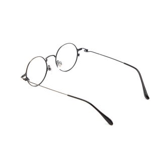 May include: A pair of eyeglasses featuring thin, dark metal frames with circular lenses. The glasses have slender temples and adjustable nose pads, showcasing a simple, lightweight construction with a matte finish on the frame structure.