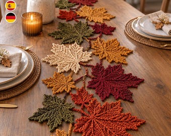 May include: A table runner composed of interconnected crocheted maple leaves in shades of red, orange, yellow, and olive green. The runner features a textured, knit-like construction with detailed veins on each leaf, arranged in a cascading pattern.