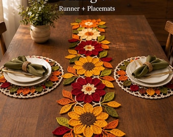 May include: An autumn-themed dining set featuring a crochet table runner and two matching round placemats. The set displays sunflower and leaf motifs in shades of yellow, orange, red, and green. Text reads Autumn Sunflower Dining Set.