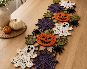May include: A Halloween-themed crochet table runner featuring interconnected motifs of white ghosts, orange jack-o'-lanterns, purple spiderwebs, black spiders, and green leaves. The runner is composed of various crocheted shapes joined together.