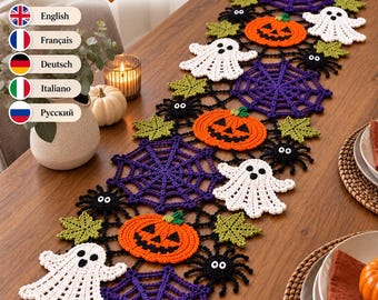 May include: A Halloween crochet table runner pattern PDF featuring orange jack-o'-lanterns, white ghosts, purple spider webs, black spiders, and green leaves. The text reads Halloween Crochet Table Runner Crochet Pattern PDF with language options.