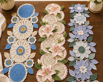 May include: A 3 in 1 Bundle Crochet Table Runner Patterns display featuring three distinct runners. One runner has blue and cream circular motifs, another features pink lily flowers on cream circles, and the third has blue and white floral shapes.