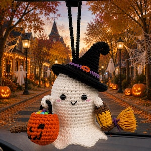 May include: A white crocheted ghost ornament wearing a black witch hat with a purple band and orange buckle. The ghost holds a small orange crocheted pumpkin bucket filled with colorful candies and a brown lantern with a yellow light.