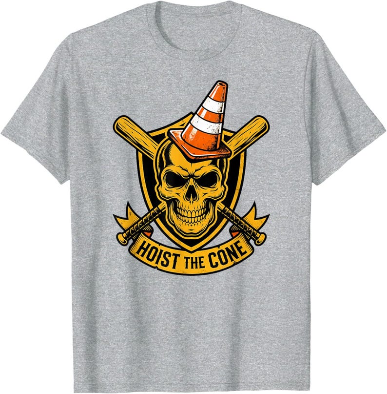 May include: A gray t-shirt featuring a graphic design. The design includes a yellow skull wearing an orange and white traffic cone, with crossed baseball bats and axes. The text "HOIST THE CONE" is displayed on a banner.