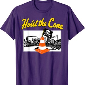 May include: Purple t-shirt with the text "Hoist the Cone" in yellow. The graphic features a black and white cityscape with a pirate flag and an orange traffic cone.