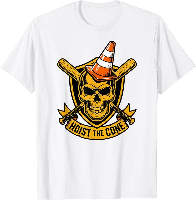 May include: White t-shirt featuring a graphic design with a skull wearing an orange and white traffic cone. The skull is set against a yellow shield with crossed baseball bats and the text "HOIST THE CONE".