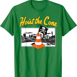 May include: Green t-shirt with the phrase "Hoist the Cone" in yellow lettering. The shirt features a graphic of an orange and white traffic cone with a pirate flag in front of a city skyline.