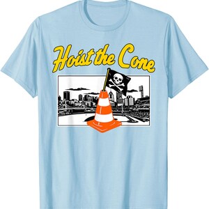 May include: Light blue t-shirt with the text "Hoist the Cone" in yellow. The graphic features an orange and white traffic cone with a skull and crossbones flag in front of a city skyline.