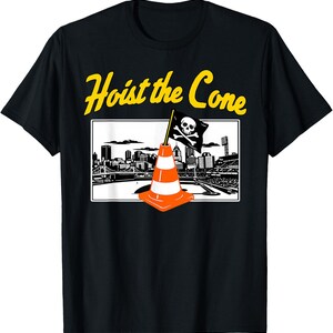 May include: Black t-shirt with the text "Hoist the Cone" in yellow. The shirt features a graphic of an orange traffic cone with a skull and crossbones flag in front of a cityscape.
