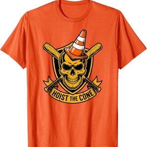 May include: Orange t-shirt featuring a graphic of a skull wearing a traffic cone, with crossed baseball bats behind it. The text "HOIST THE CONE" is displayed on a banner below the skull.