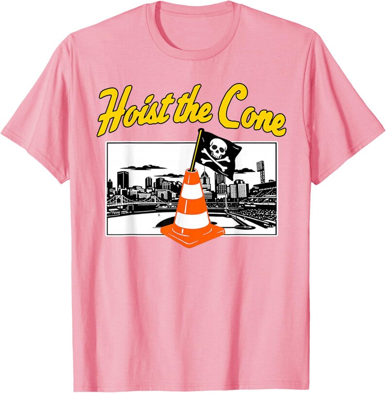 May include: Pink t-shirt with a graphic featuring a traffic cone with a skull and crossbones flag, set against a cityscape. The text "Hoist the Cone" is in yellow above the graphic. A fun, novelty tee.