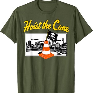 May include: Olive green t-shirt with the text "Hoist the Cone" in yellow. The graphic features a traffic cone with a skull and crossbones flag in front of a city skyline.