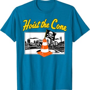 May include: A turquoise t-shirt with a graphic that says "Hoist the Cone" in yellow text. The graphic features a pirate flag on a traffic cone in front of a city skyline.