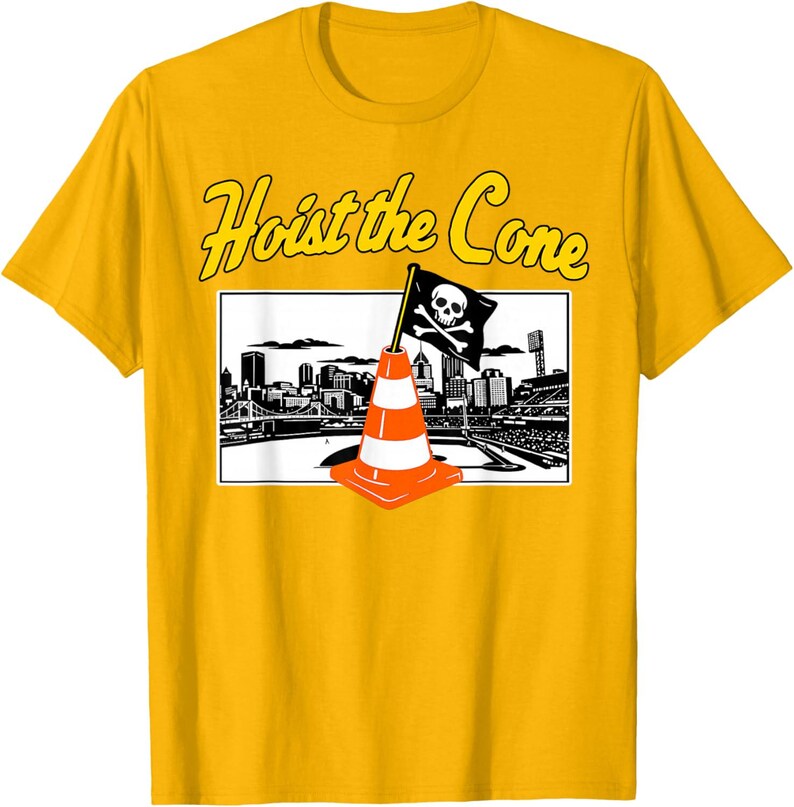 May include: A yellow t-shirt featuring a graphic with the text "Hoist the Cone." The graphic includes a black and white cityscape, an orange and white traffic cone, and a pirate flag with a skull and crossbones.