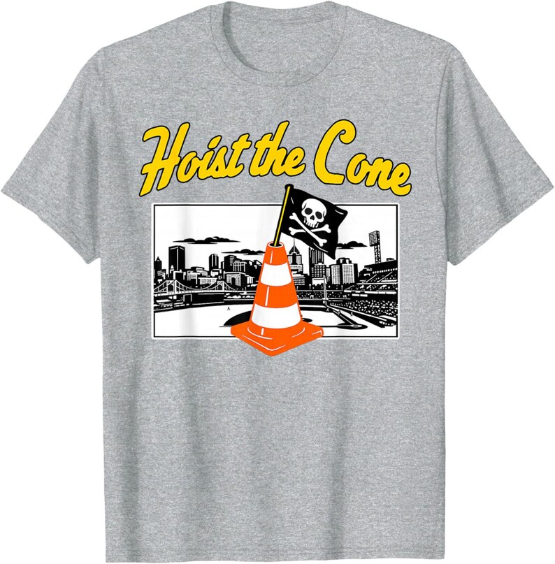 May include: Gray t-shirt featuring a graphic with the text "Hoist the Cone" in yellow. The graphic includes an orange and white traffic cone with a pirate flag, and a black and white cityscape.