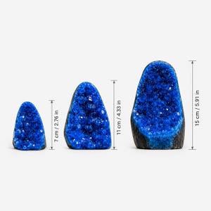 May include: Three blue geode specimens with crystalline interiors and dark outer shells. The heights are indicated as 2.76 inches, 4.33 inches, and 5.91 inches, showing a progression in size from the smallest to the largest crystal formation.