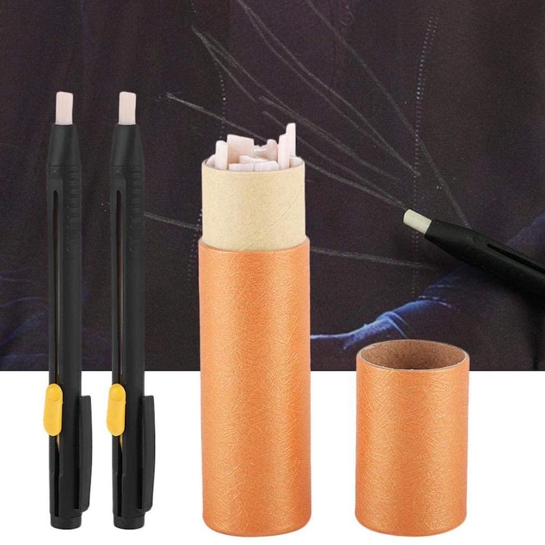 May include: A set of art erasers and a storage container. The erasers are black with a white eraser tip and yellow slider. The container is orange and cylindrical, with a beige interior. The set includes a container of eraser refills.